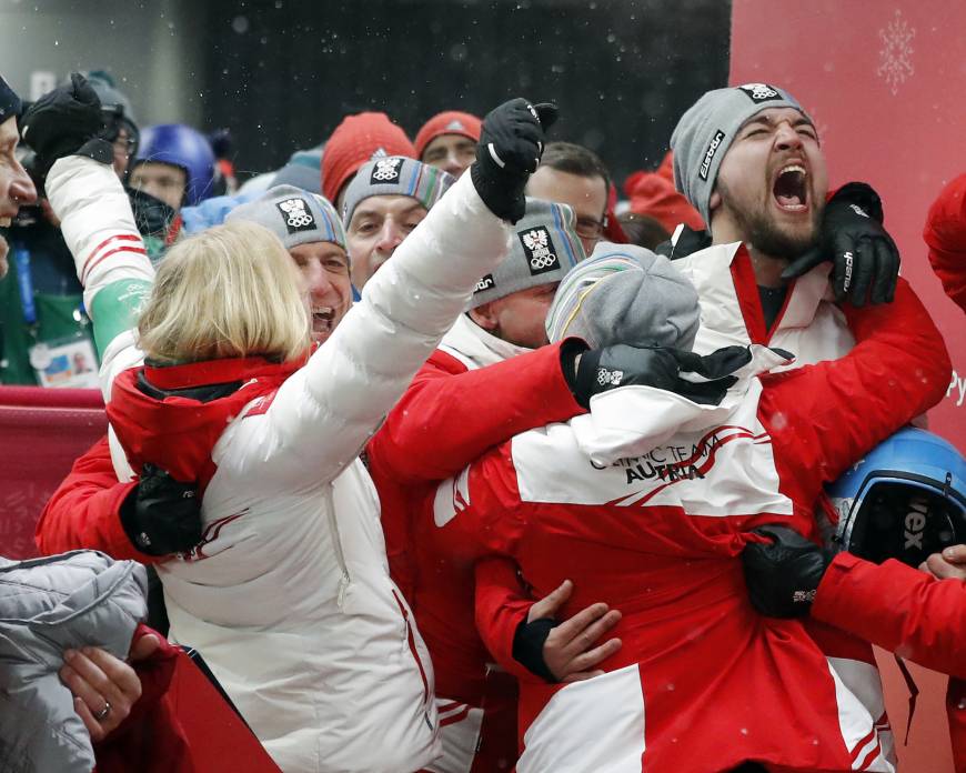 David Gleirscher of Austria, right, celebrates after winning the gold medal in the men
