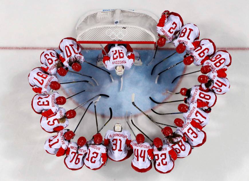 Olympic athletes from Russia huddle before their match against Canada in a Preliminary Round Match.
