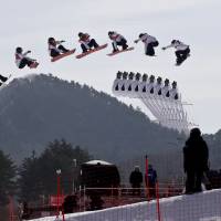 In this multiple exposure image Yuka Fujimori, of Japan, jumps during qualification for the women’s big air snowboard competition on Monday. Who to watch for Day 14 (Thursday, Feb. 22)
