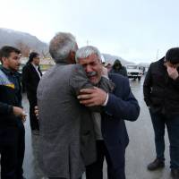 Relatives of passengers who were believed to have been killed in a plane crash react near the town of Semirom, Iran, Sunday. Iran delays hunt for airliner lost in mountain blizzard with 66 aboard