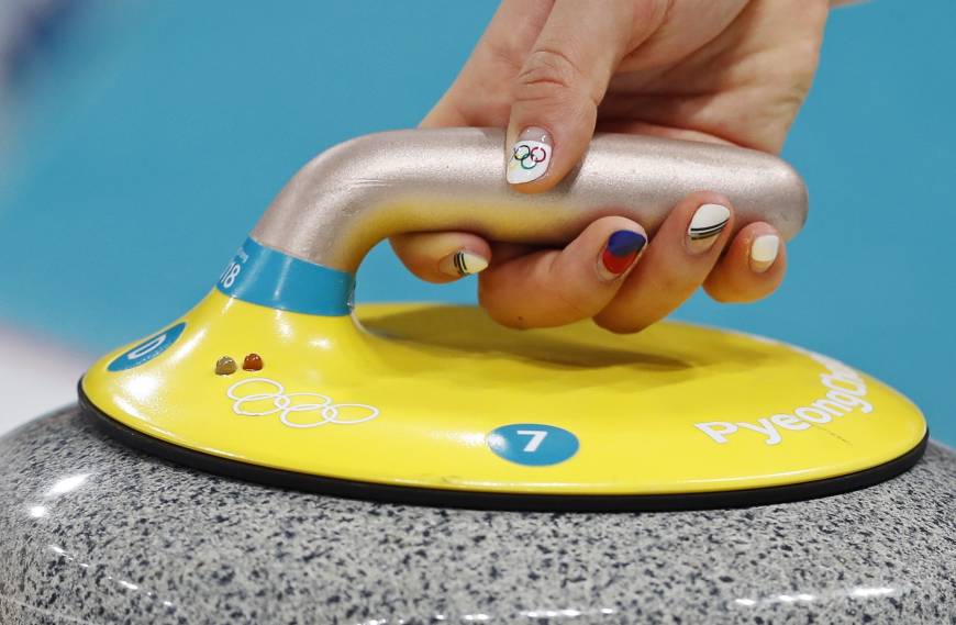 A close-up shows the nails of Kim Kyeong-ae of South Korea as she delivers a stone during the women
