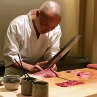 Hiroyuki Sato prepares chutoro tuna. Hakkoku