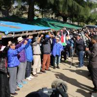 People take part in a rally in front of Camp Schwab in Nago, Okinawa, on Dec. 26 as the sit-in protest against the relocation of U.S. Marine Corp’s Futenma air station from Okinawa’s Ginowan city to Nago reached 5,000 days. The four <I>mottainai</I> in Okinawan affairs