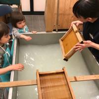 Ozu Washi instructor Nao Tanaka demonstrates how to pick up a film of pulp that will eventually dry into a sheet of paper. <I>Washi </I>workshop: Good on paper, better firsthand