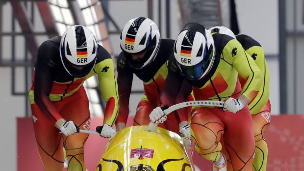 (From left) driver Francesco Friedrich, Candy Bauer, Martin Grothkopp and Thorsten Margis of Germany start their third heat in the four-man bobsled final on Sunday at the Pyeongchang Olympics. They won the gold medal. German squad completes sweep of bobsled gold medals