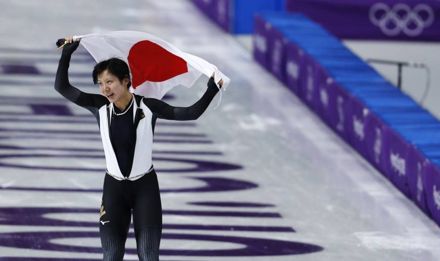 Silver medallist Miho Takagi of Japan holds the national flag after the women