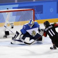 Canada’s Jillian Saulnier scores a second-period goal against Finland’s Noora Raty in a women’s hockey preliminary round game on Tuesday in Gangneung, South Korea. Canada trounces Finland, remains unbeaten