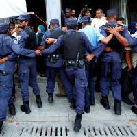 Maldivian Police officers push back opposition supporters near the main opposition Maldives Democratic Party (MDP) headquarters during a protest demanding the government to release jailed opposition leaders, including former Presidents Mohamed Nasheed and Maumoon Abdul Gayoom, in line with a Supreme Court order, in Male, Maldives, on February 9, 2018. China's naval presence deterred Indian intervention in Maldives crisis: sources