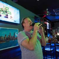 Operatic tenor Lucas Meachem, who is performing in “La Boheme” at the Met, sings at a karaoke bar in New York on March 8. Rising opera star was discovered in karaoke bar