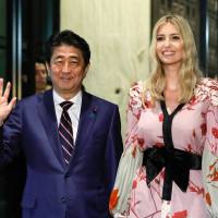 Prime Minister Shinzo Abe and Ivanka Trump, assistant to U.S. President Donald Trump and the wife of Jared Kushner, pose for photographers as they arrive for a dinner in Tokyo, Japan, on Friday, Nov. 3, 2017. Brooklyn sale by Kushner family firm, at 60% premium, linked to NTT — one-third owned by Japan's government