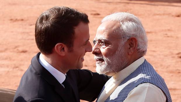 French President Emmanuel Macron hugs Indian Prime Minister Narendra Modi during a ceremonial reception in New Delhi on Saturday. Macron pledges €700 million for new solar projects at New Delhi meet