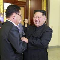 North Korean leader Kim Jong Un greets a member of the South Korean delegation sent by President Moon Jae-in ahead of a group dinner in this photo released Tuesday. Two Koreas agree to leaders' summit as North voices openness to denuclearization