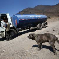 A water tanker crosses through the dry bed of the La Ligua River in Chile’s La Ligua province on March 2. Last three years hottest on record: U.N.