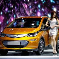 A model poses with a Chevrolet Bolt EV during the 2017 Seoul Motor Show in Goyang, South Korea, on Saturday. How Seoul raced to conclude U.S. trade deal ahead of North Korea denuclearization summit