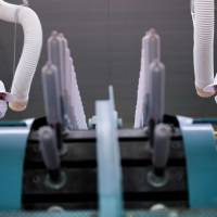 Employees of Japanese condom maker Sagami Rubber Industries perform quality tests on randomly picked condoms at the company’s testing facility in Atsugi, Kanagawa Prefecture, in January. Japanese condom-makers hope for rise in sales from 2020 Tokyo Olympics