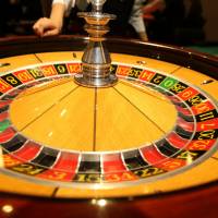A ball rolls on a spinning roulette wheel at a mock casino in Tokyo. Komeito, the junior coalition partner of the ruling Liberal Democratic Party, reportedly plans to call for gamblers to pay an admission fee of at least ¥8,000 for planned casinos. Komeito favors ¥8,000 admission fee for casinos to match Singapore