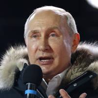 Russian President Vladimir Putin speaks to supporters during a rally near the Kremlin on Sunday. | AP