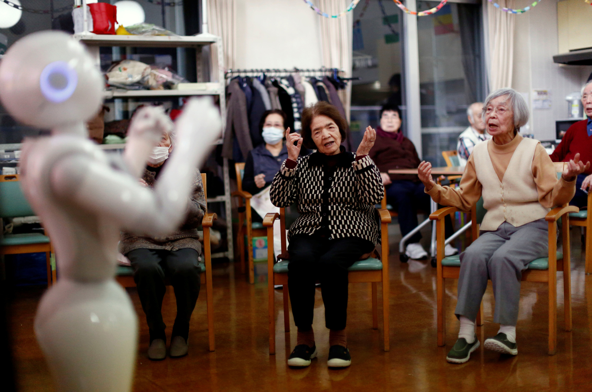 Residents follow moves made by the humanoid robot Pepper during an afternoon exercise routine at the Shintomi nursing home in Tokyo on Feb. 2.