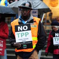 Protesters gather outside a World Affairs Council meeting on the Trans Pacific Partnership in Portland, Oregon, on March 21, 2016. Will Trump rejoin the Trans-Pacific Partnership? Let's hope so