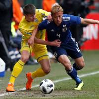Ukraine’s Eduard Sobol (left) tries to stop Japan’s Keisuke Honda during their friendly on Tuesday in Liege, Belgium. Ukraine won 2-1. Japan stumbles against Ukraine in World Cup warm-up