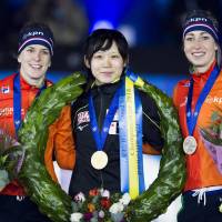 Gold medalist Miho Takagi (center) poses with silver medalist Ireen Wust (left) and bronze medalist Annouk van der Weijden, both of the Netherlands, after the ISU World Allround Speedskating Championships on Saturday in Amsterdam. Miho Takagi captures allround world title