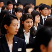Newly hired employees of Sumitomo Corp. attend an initiation ceremony at the company’s headquarters in Tokyo on Monday Japan's new fiscal year starts amid government scandal and higher food prices