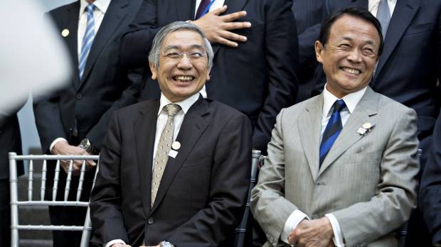 Finance Minister Taro Aso (right) and Bank of Japan Gov. Haruhiko Kuroda laugh while attending a Group of 20 finance ministers and central bank chiefs group photo on the sidelines of the spring meetings of the International Monetary Fund (IMF) and World Bank in Washington on Friday. G-20 finance chiefs wary of trade friction but short on solutions