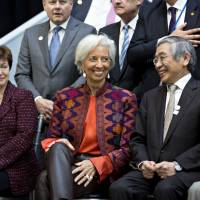 Haruhiko Kuroda (second from right), governor of the Bank of Japan, and Finance Minister Taro Aso, take part in a Group of 20 finance ministers’ and central bank governors’ group photo on the sidelines of the spring meetings of the International Monetary Fund and World Bank, in Washington, D.C., on Friday. Japan risks getting left behind as G-20 wrestles with monetary tightening issue
