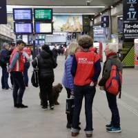 Employees help commuters on Sunday at the Gare Montparnasse train station in Paris as French rail workers launched their latest two-day strike over plans to overhaul the heavily indebted train operator SNCF, the biggest test yet to French President’s drive to reform the country’s economy. Neither side appears ready to back down, with Prime Minister warning that the government would not be deterred despite union pledges for three months of rolling stoppages, and possibly more. French rail strikes resume as unions square off with Macron, gird for 'marathon'