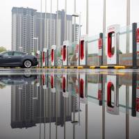 Zang Yi charges her Tesla car at a charging point in Beijing April 13. Zang said if the trade tensions resulted in pricier U.S. imports, she wouldn’t consider American brands when the time comes to buy a new car. Trump's next $100 billion tariff dilemma: Hit Walmart or Apple?