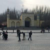 Children play outside the Id-kah mosque in Kashgar, in China’s western Xinjiang region, on Feb. 18. The predominantly Uighur area has become one of the most policed places on earth. 'Eradicate the tumors': Chinese civilians drive Xinjiang crackdown on separatism