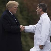 U.S. President Donald Trump shakes hands with White House Physician Rear Adm. Dr. Ronny Jackson in January following his annual physical at Walter Reed National Military Medical Center in Bethesda, Maryland. The Senate on Tuesday postponed a confirmation hearing for President Trump’s pick to lead the Department of Veterans Affairs, expressing concerns about “serious allegations” facing the controversial nominee. Memo alleges VA nominee doled out opioids, crashed car while drunk but White House defends his vetting
