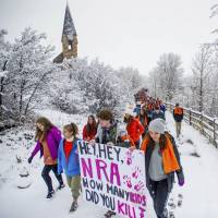 Aspen High School students march to Paepcke Park for a student-organized walkout protesting gun violence on Friday in Aspen, Colorado. In new walkouts, U.S. students look to turn outrage over guns into action