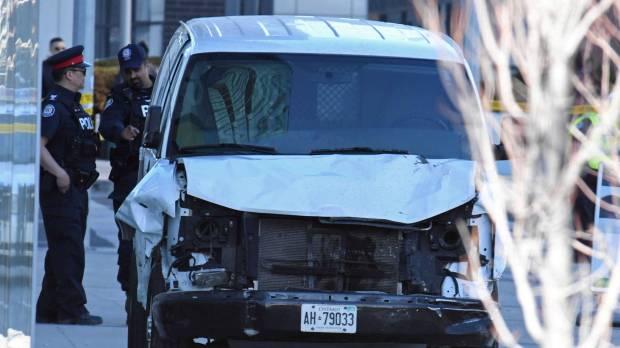 A damaged van seized by police is seen after multiple people were struck at a major intersection Toronto on Monday. Motive elusive after van driver kills 10 on Toronto sidewalk