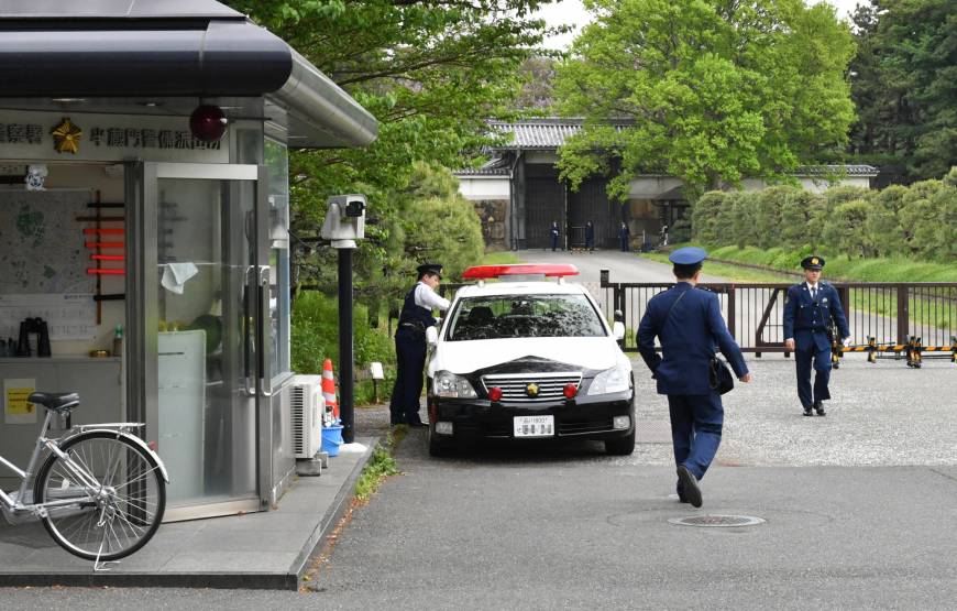 Police officers guard the Imperial Palace