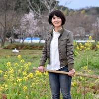 Kiyoko Ojima, who helps homeless and other needy people by giving them opportunities to work in agriculture, is seen at her field in Fujisawa, Kanagawa Prefecture, on March 19. In Kanagawa, homeless grow crops and confidence