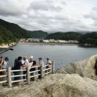 Geologists employed by UNESCO examine geographical features in the town of Nishiizu, Shizuoka Prefecture, in July that was created by the eruption of a submarine volcano. UNESCO designates Izu Peninsula as Japan's 9th 'Global Geopark'