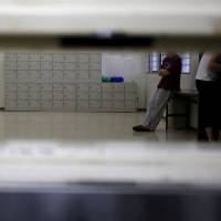 Detainees are seen through a hatch at the Tokyo detention center which is part of the Tokyo Regional Immigration Bureau in Tokyo, December 2, 2015. Indian man dies in Japanese immigration detention center in apparent suicide