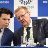 International Olympic Committee (IOC) Vice President John Coates (right) chats with IOC Olympic Games executive director Christophe Dubi during a news conference following the IOC project review meeting in Tokyo on Tuesday. IOC to remain 'politically neutral' toward North Korea's involvement in 2020 Tokyo Olympics: vice president
