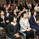 Korean residents who gathered at the Korean Cultural Center in Osaka on Friday applaud as they watch a live broadcast of North Korean leader Kim Jong Un and South Korean President Moon Jae-in shaking hands.
