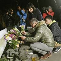 Takuya Yamato, 59, and his wife, Shinobu, 50, pray on Monday for their son, Hikaru, who was 22 when he died in the earthquake that struck the village of Minamiaso, Kumamoto Prefecture, exactly two years ago. His body was recovered about four months afterward. Kin of last confirmed victim of Kumamoto quakes mark second anniversary of disaster