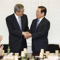 Liberal Democratic Party members Wataru Takeshita (left) and Fukushiro Nukaga shake hands on April 19 in Tokyo as Takeshita takes over what was once its most powerful faction. Under new management: LDP's Takeshita faction looks to regroup, field viable candidate
