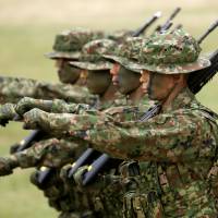 Personnel from the Ground Self-Defense Force’s Amphibious Rapid Deployment Brigade, Japan’s first marine unit since World War II, take part in a ceremony at Camp Ainoura in Sasebo, Nagasaki Prefecture, on Saturday. Japan's new marines make their debut, but much preparatory work remains to be done