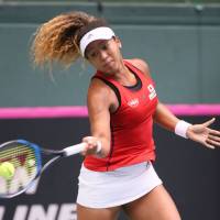 Japan’s Naomi Osaka hits a return to Britain’s Heather Watson in their Fed Cup World Group II playoff match on Saturday in Miki, Hyogo Prefecture. Japan, Britain tied in Fed Cup clash