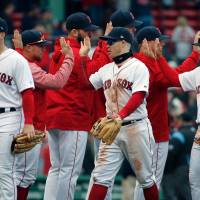 The Red Sox congratulate each other following their victory over the Orioles on Saturday in Boston. Red Sox enjoying best start in 118-year history