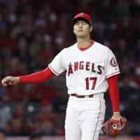 Shohei Ohtani reacts after walking Boston’s Mookie Betts during the second inning of the Angels’ game against the Red Sox on Tuesday. Blister curtails Shohei Ohtani's start against Red Sox