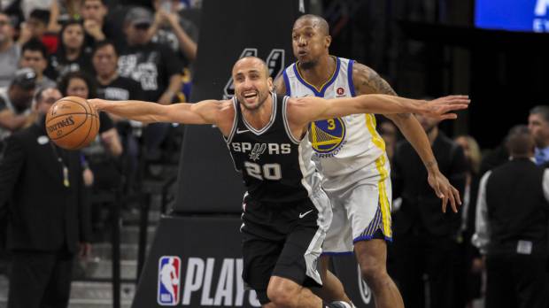 Spurs guard Manu Ginobili (front) goes for a loose ball in front of the Warriors’ David West on Sunday. Ginobili carries Spurs in Game 4