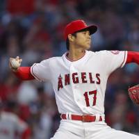 Angels starter Shohei Ohtani pitches against the Red Sox on Tuesday in Anaheim, California. Ohtani left the game after two innings because of a blister on his finger. Angels' Shohei Ohtani eager to get back on mound