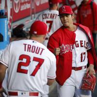 Los Angeles Angels hurler Shohei Ohtani (right), greeting teammate Mike Trout in the dugout on Tuesday in Anaheim, California, isn’t expected to miss a start despite a blister on the middle finger of his right hand. Despite blister, Angels' Shohei Ohtani expected to make next start