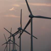 Wind turbines operate at a farm in Kamisu, Ibaraki Prefecture. Japan's draft energy plan focuses on renewable energy infrastructure, but power source targets left unchanged